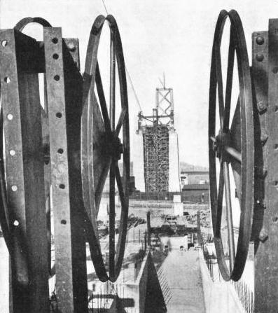 THESE LARGE WHEELS were mounted at the end of the suspension bridge to reel out the cables supporting the roadways