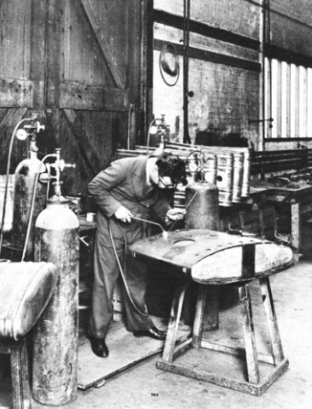 A PETROL TANK being built by welding the sections together