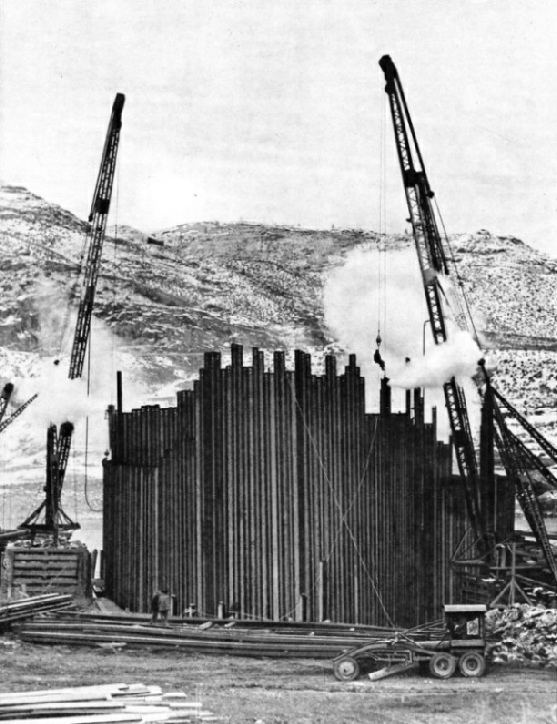 GIANT COFFERDAM of sheet steel piling being built to divert the Columbia River