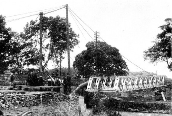 TWO LIGHT DERRICKS and simple tackle served to launch the completed unit span in position