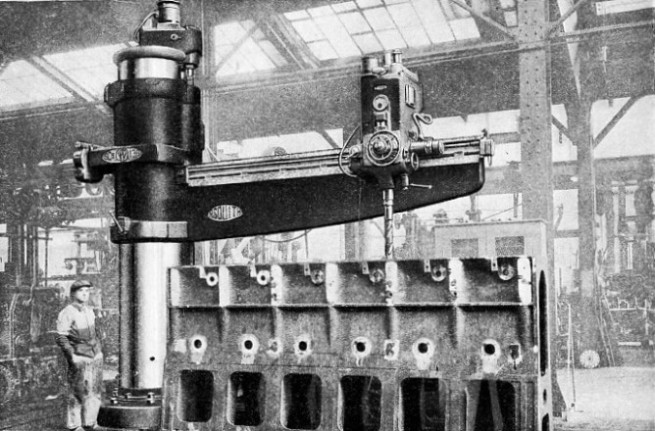 RADIAL DRILLING MACHINE engaged in drilling the cylinder block of a large diesel engine