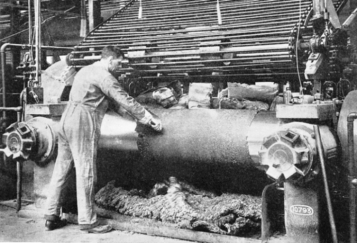 MASTICATING MILL, in which raw rubber is worked between large steel rollers